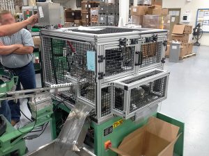 black aluminum grid with silver aluminum edge and a machine inside