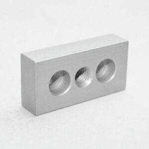 Silver metal block with three circular holes on one face, center hole threaded for fastener