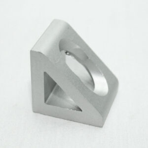 Silver geometric metal sculpture with a triangular outer frame and a circular cutout, resting on a white surface.