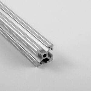Close-up of a silver aluminum T-slot extrusion with three parallel grooves, angled on a light gray background.