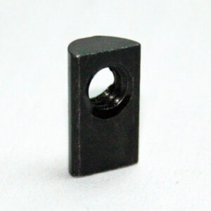 Small black rectangular block with a circular hole through its center, on a white surface.