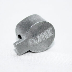Small gray metal cylindrical pin with a flat rectangular tab and a side hole, engraved FAZTEK. (informative)