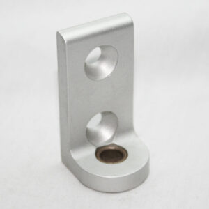 Silver L-shaped metal mounting bracket with two holes on the upright arm and a recessed base hole with a brown insert.