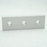 Light gray rectangular metal block with three circular holes arranged in a row on a white background.