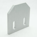 Light gray, house-shaped metal block with two vertical rounded slots on a white background.