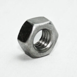 Metal hex nut lying on a white surface, showing its threaded interior and six flat sides (hardware fastener).