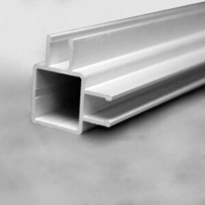 Close-up of a white plastic extrusion with a serrated inner lip, angled across a gray background.
