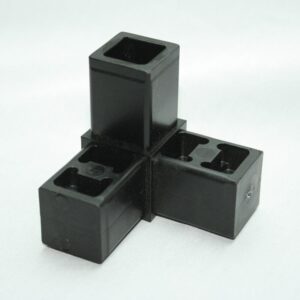 Four black square plastic blocks with hollow centers arranged in a cross on a white background