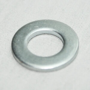 Flat, shiny metal washer resting on light fabric surface