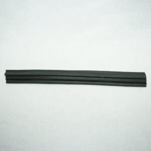Black rubber wiper blade strip laid flat on a white surface for scale.