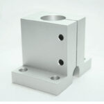 Silver aluminum L-shaped mounting bracket with a large circular through-hole on top and two threaded holes on the vertical face, set on a white background.