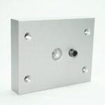Square aluminum mounting plate with five threaded holes and a central through-hole for assembly.