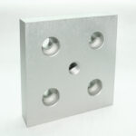 Silver aluminum mounting plate with four large holes and a central threaded hole.