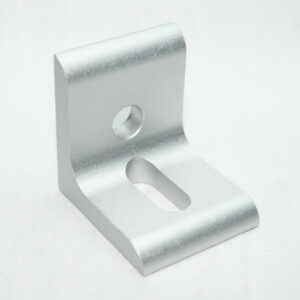 Silver metal L-bracket with a circular hole and an oval slot, likely used as a mounting or shelf support.