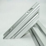 Close-up of stacked silver aluminum rails with grooved edges