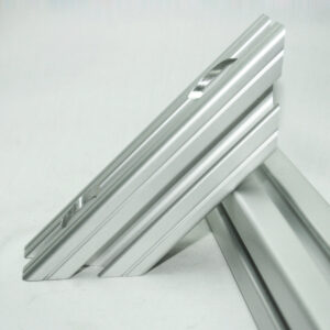 Close-up of stacked silver aluminum rails with grooved edges