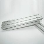 Set of silver aluminum drawer slides stacked on a white background.