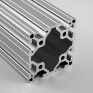 Close-up of a silver aluminum extrusion with multiple T-slot channels for modular framing.