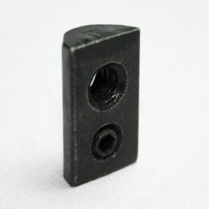 Small black rectangular metal block with two threaded holes, standing on a white surface.