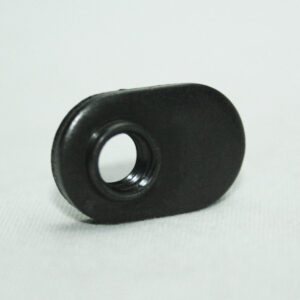 Small black rubber grommet with a central hole resting on a white surface.