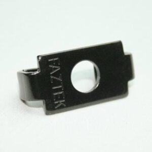 Close-up of a small black metal mounting clip with a central circular hole and stamped text along the edge.