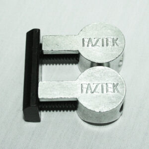 15FAC3882_4__editedjpg | Faztek Industrial Solutions Dual Faztek clamping blocks mounted on a black base with threaded screws on a light surface, showing a compact industrial fixture.