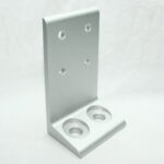 Silver metal L-shaped mounting bracket with two large holes on the base and four smaller holes on the upright for screws.