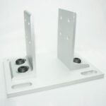 Silver metal mounting bracket with two vertical plates attached to a flat base with hole openings for bolts and grommets