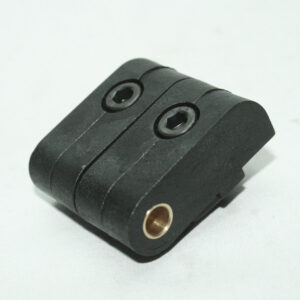 Black two‑hole mounting clamp/adapter with hex socket recesses on top and a brass threaded insert on the side, likely used to attach accessories to a rod or rail