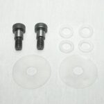 Two short metal bolts with knurled heads and threaded ends, plus white plastic washers of various sizes laid out on a light background—likely a mounting hardware kit for spacers and bushings.