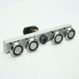Bar-style control plate with four chrome knobs and a central black unit on a white background (instrument panel component).