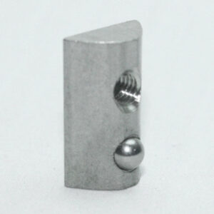 Small metallic block with a threaded hole and a protruding ball detent on one edge.