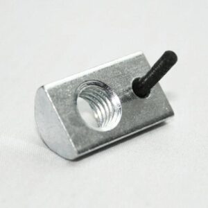 Close-up of a small silver metal block with a threaded hole and a short black pin protruding from its side.