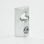 Metal detent ball plunger with a threaded hole, standing on a white surface.