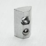Small silver metal block with a threaded hole on top and a round bore with a ball inside, set against a white background.