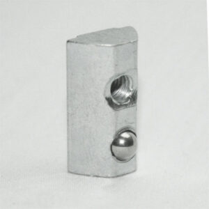 Metal rectangular block featuring a threaded hole and a protruding steel ball detent on its right face (ball plunger component).