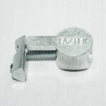 Small silver metal clamp with a threaded screw and a curved jaw, engraved FAZTEK.