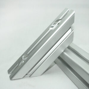Close-up of two silver aluminum framing rails with beveled edges resting at a diagonal angle.