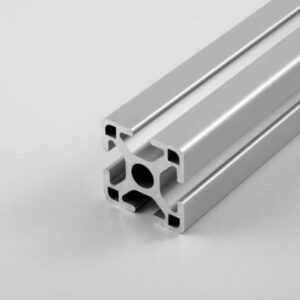 Silver aluminum T-slot extrusion with square central bore and side channels, photographed on a light gray surface.