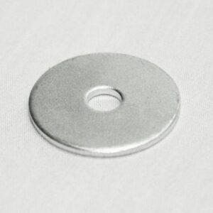 Flat silver metal washer with a central hole resting on a light surface.