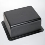 Closed black leather jewelry display box on a white background, angled view
